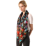 Belmore Boutique black and gold hummingbird print silk scarf on model. 